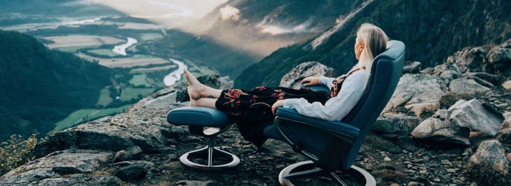 Woman relaxing in nature sitting in a Stressless recliner